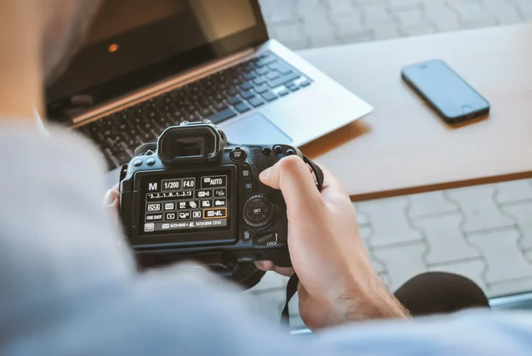 A man is taking a picture with a dslr camera.