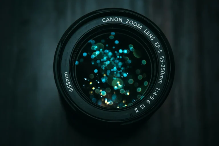 A close up of a camera lens on a dark background.